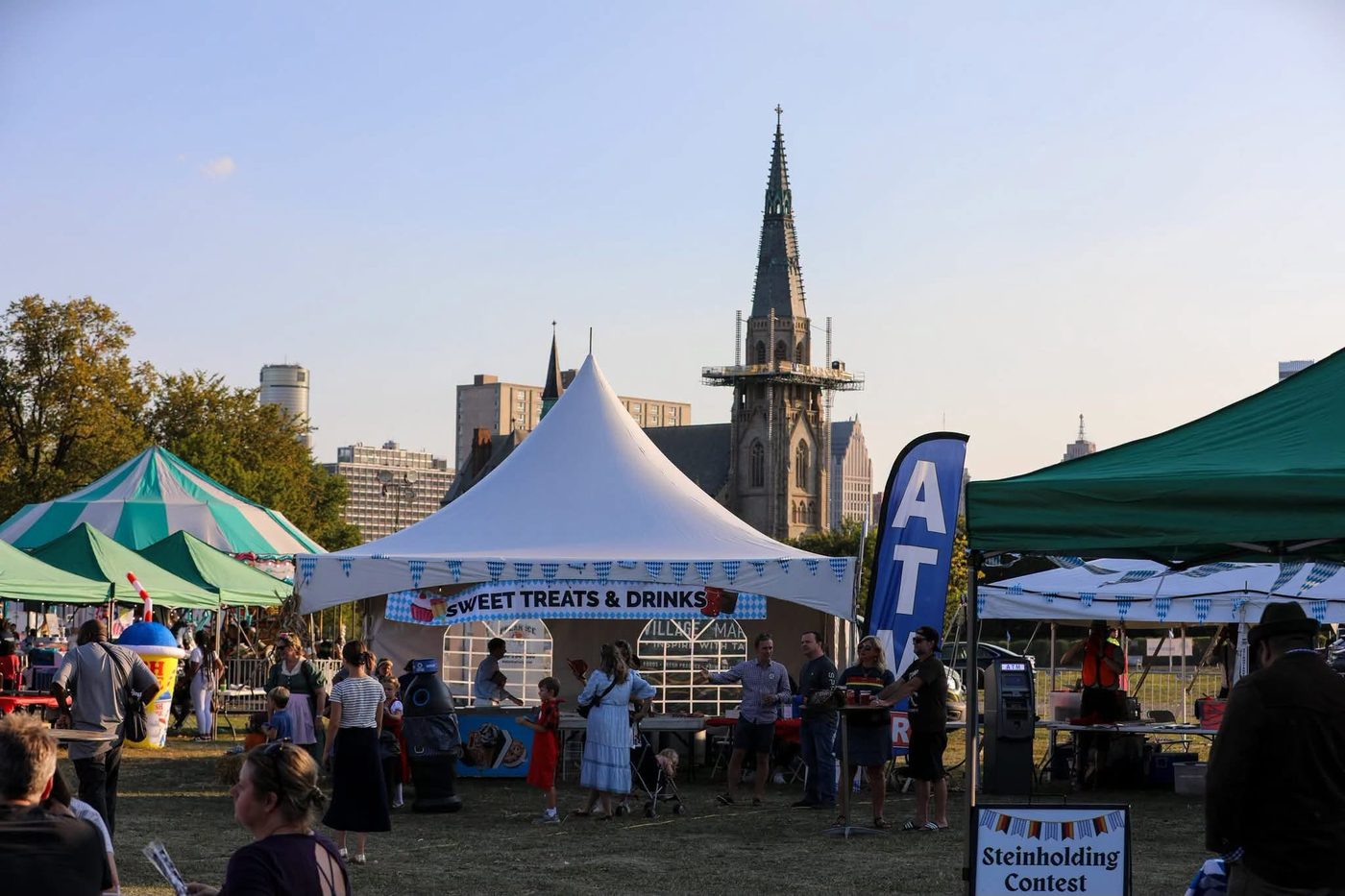 Oktoberfest tents at DeSales Park with the St. Joseph Shrine spire rising behind them